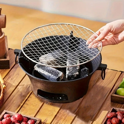 Barbecue - portable - fonte - 23cm - une - main - posant - la - grille - dessus