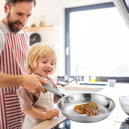 Poêle- en- acier- inoxydable- poli- rond-  induction :  père- cuisinant- avec- sa- fille